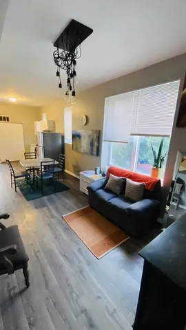 a living room with furniture and a chandelier