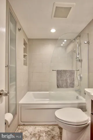 a bedroom with a bed and a desk