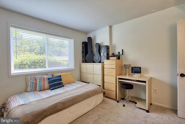 a view of a kitchen with a sink and a refrigerator
