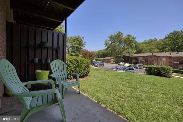 a view of a kitchen with fridge and wooden floor