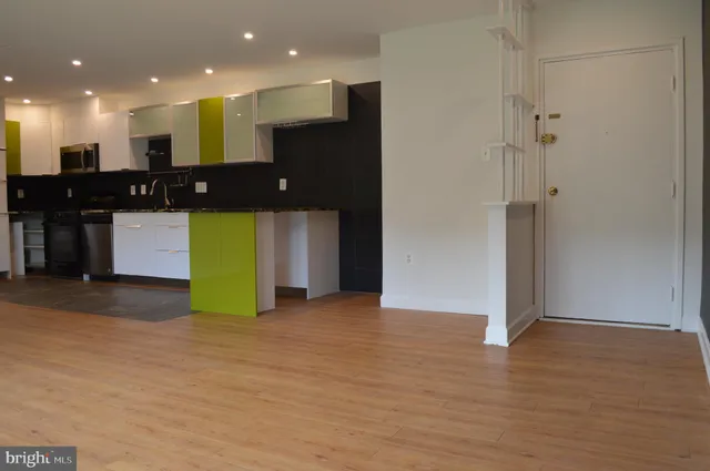 a kitchen with stainless steel appliances a sink stove and cabinets