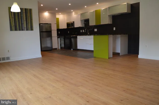 a stove top oven sitting inside of a kitchen