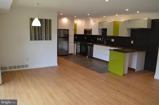 a view of an empty room with a kitchen