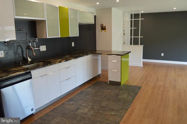 an empty room that has a grey walls