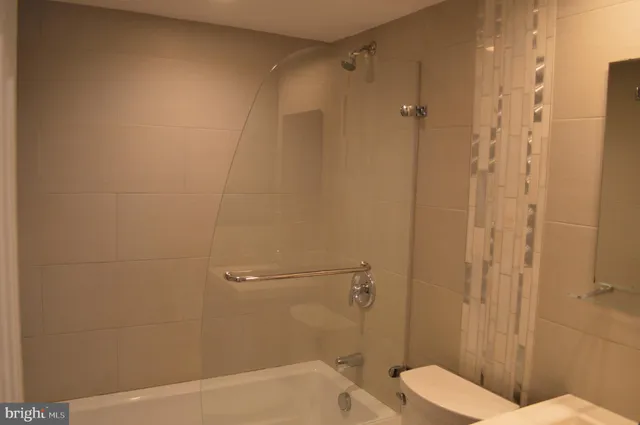 a kitchen with stainless steel appliances kitchen island granite countertop a refrigerator a stove and a sink