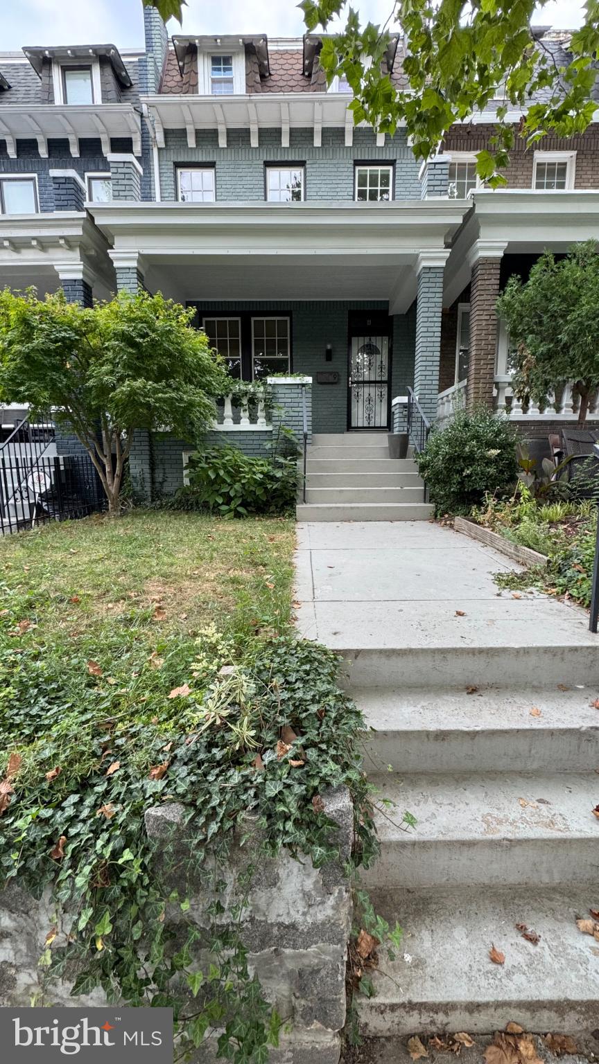 a front view of a house with a garden