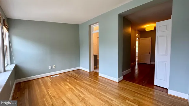 wooden floor in an empty room with a window