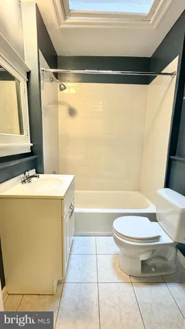 a bathroom with a sink a toilet a mirror and a bathtub