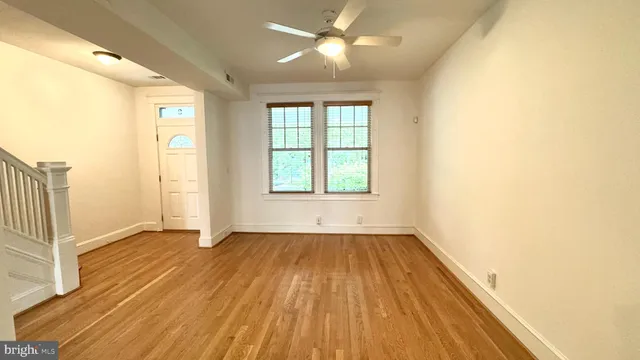wooden floor in an empty room with a window
