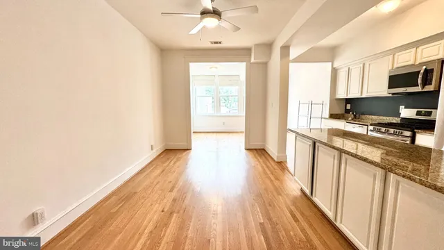 a kitchen with stainless steel appliances a stove top oven a sink and a refrigerator