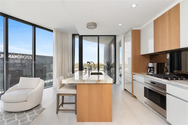a kitchen with stainless steel appliances granite countertop a sink a stove and a refrigerator