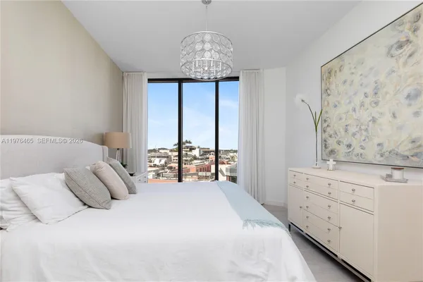 a large white bed in a white room