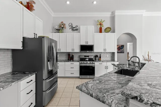 a kitchen with stainless steel appliances granite countertop a stove and a sink