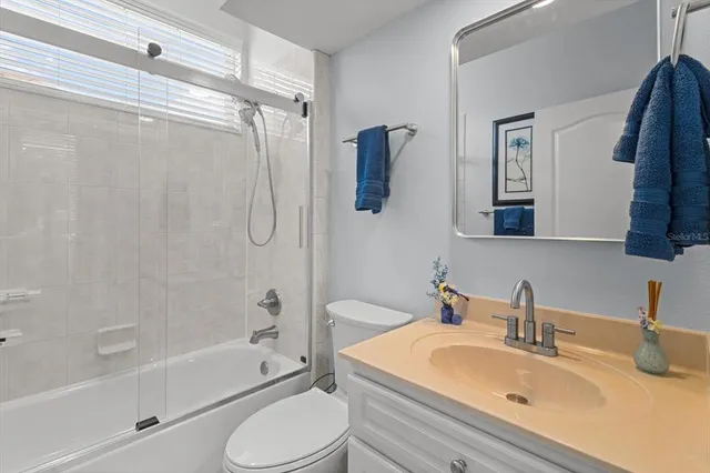 a bedroom with a bed and a flat tv screen on the table