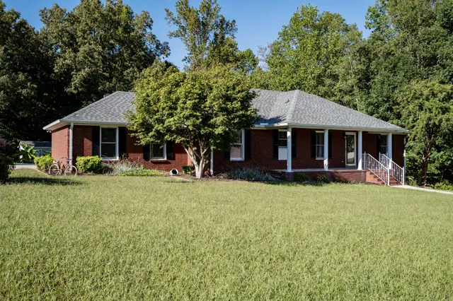 a front view of a house with a garden