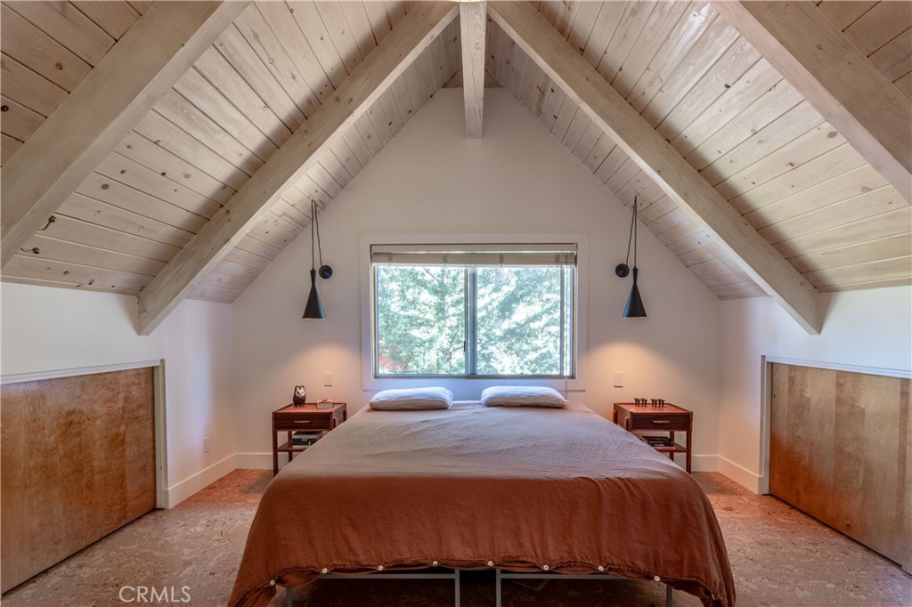 26704 Raven Road Wrightwood, CA 92397 - Photo 12 of 19 a bed sitting in a bedroom next to a window