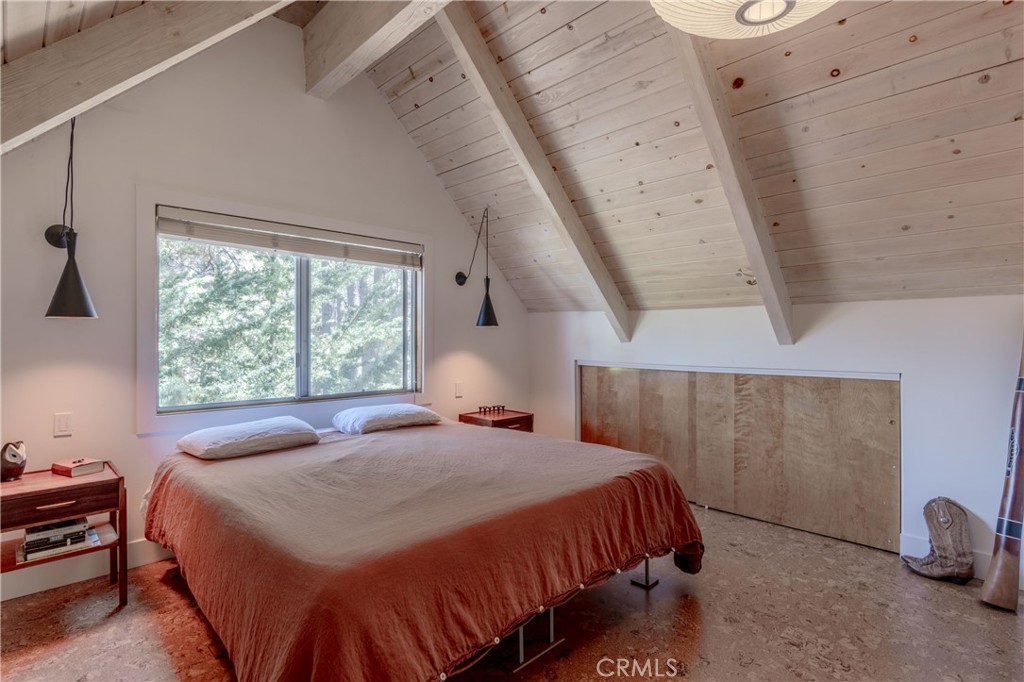 26704 Raven Road Wrightwood, CA 92397 - Photo 13 of 19 a bedroom with a bed and a window