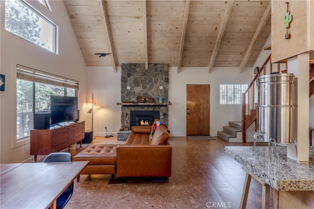 26704 Raven Road Wrightwood, CA 92397 - Photo 16 of 19 a living room with furniture and a fireplace