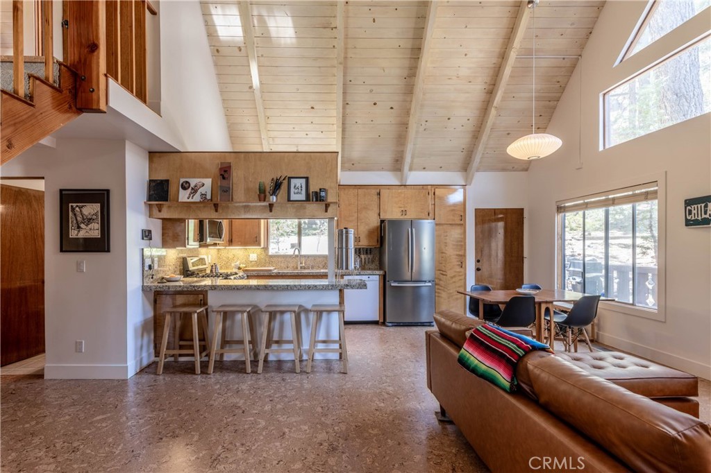 26704 Raven Road Wrightwood, CA 92397 - Photo 5 of 19 a living room with stainless steel appliances kitchen island granite countertop furniture and a large window