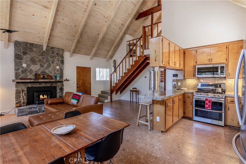 26704 Raven Road Wrightwood, CA 92397 - Photo 6 of 19 a living room with furniture fireplace and a flat screen tv