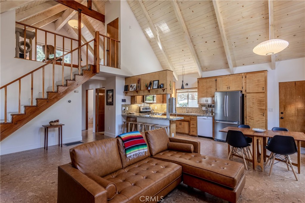 26704 Raven Road Wrightwood, CA 92397 - Photo 7 of 19 a living room with furniture and a chandelier