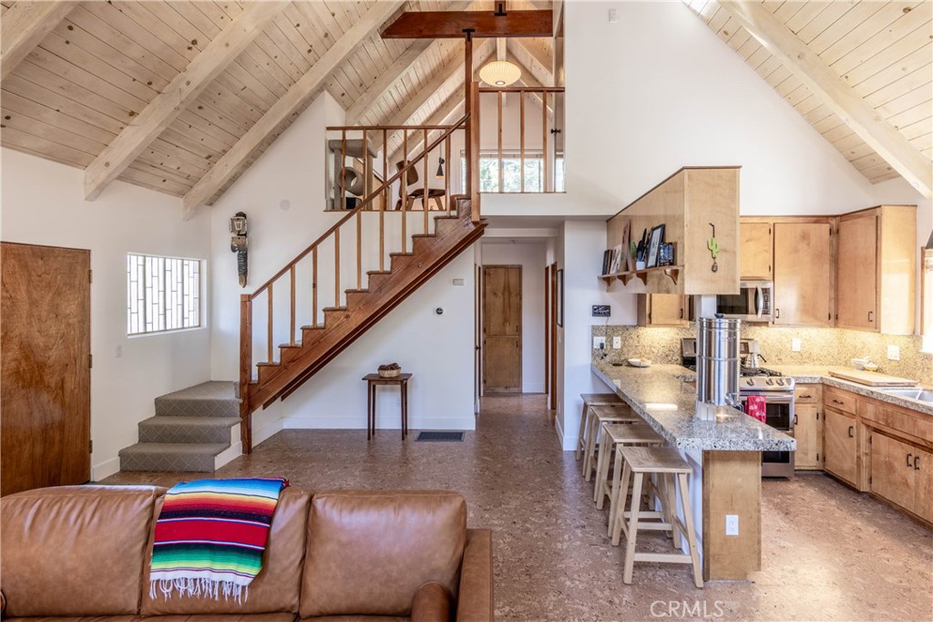 26704 Raven Road Wrightwood, CA 92397 - Photo 8 of 19 a living room with furniture and a flat screen tv