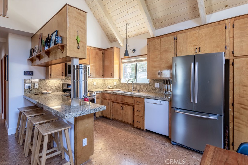 26704 Raven Road Wrightwood, CA 92397 - Photo 9 of 19 a kitchen with stainless steel appliances granite countertop a refrigerator a oven a sink and a stove