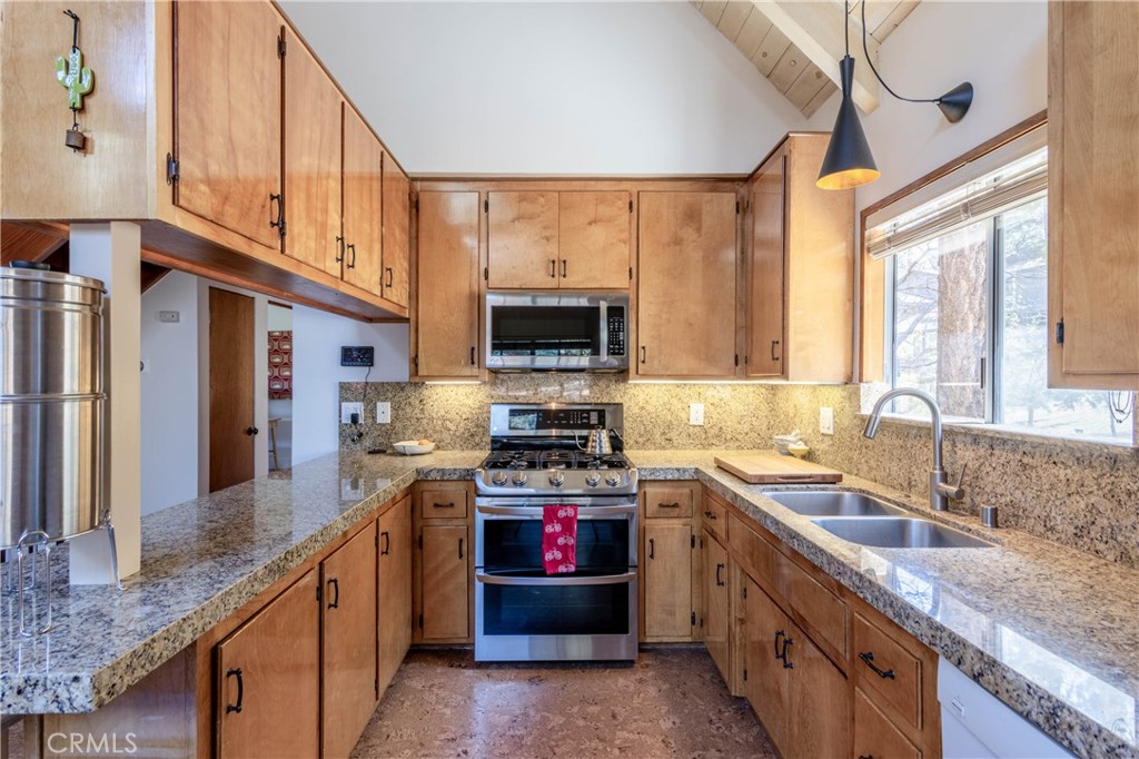 26704 Raven Road Wrightwood, CA 92397 - Photo 10 of 19 a kitchen with stainless steel appliances granite countertop a stove a sink and a microwave