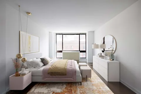 a bedroom with a bed couch and window