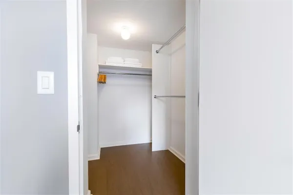 a view of a hallway with wooden shelves