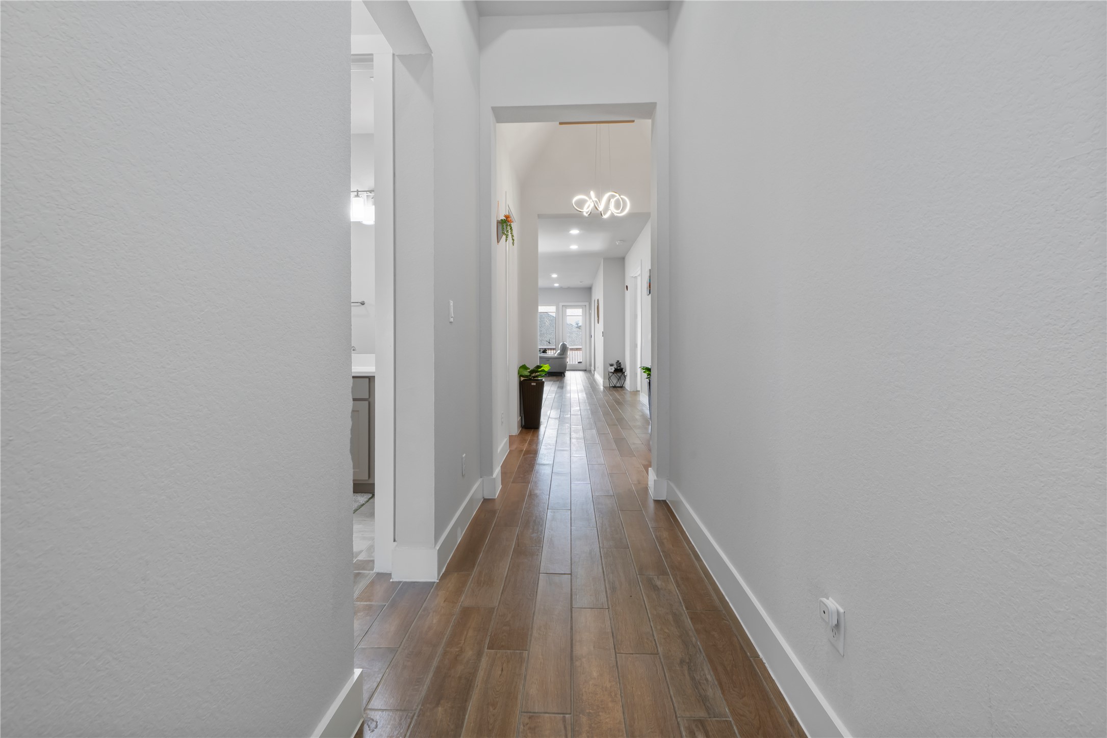 224 Grn Knl Lane Georgetown, TX 78628 - Photo 4 of 38 a view of a hallway with wooden floor