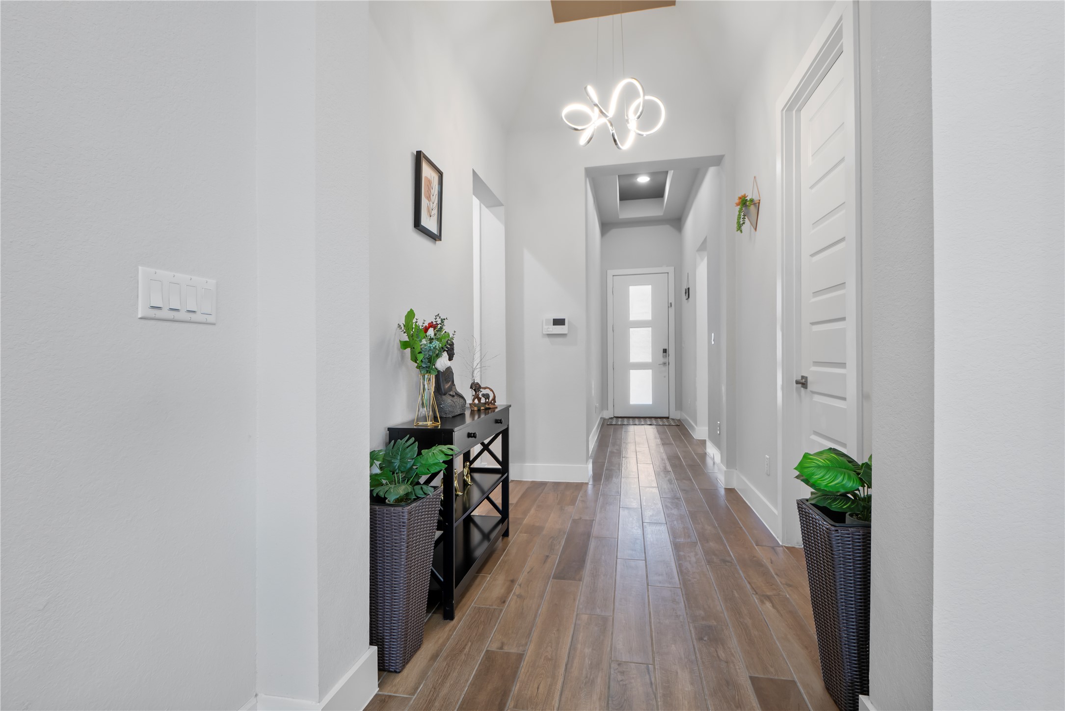 224 Grn Knl Lane Georgetown, TX 78628 - Photo 5 of 38 a view of a hallway with wooden floor and glass door
