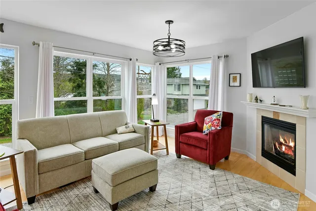 a living room with furniture a flat screen tv and a fireplace