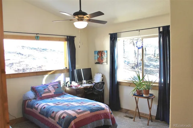 a bedroom with a large bed and a window