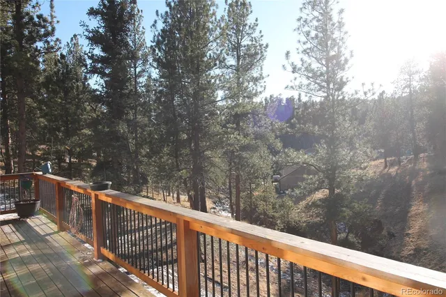a balcony with trees in front of it