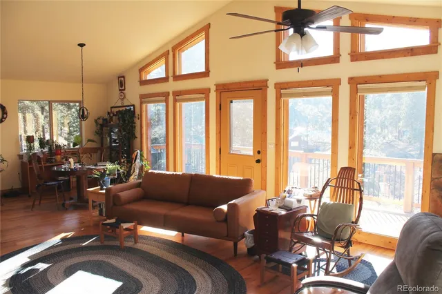 a living room with furniture and floor to ceiling windows