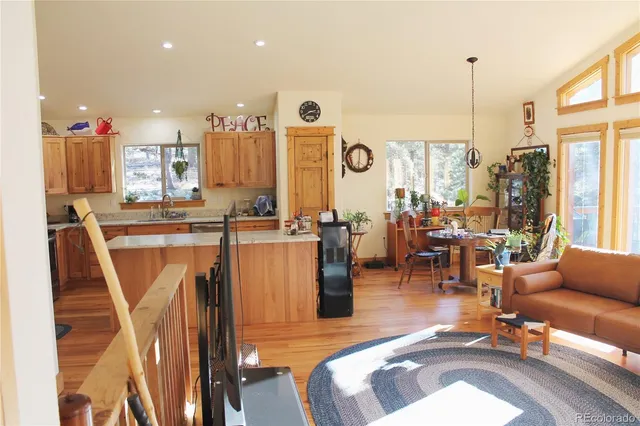 a living room with furniture a flat screen tv and a large window