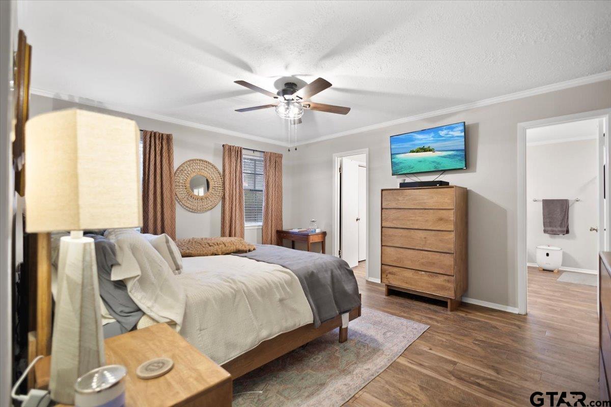 1606 Timothy Street Henderson, TX 75654 - Photo 11 of 33 a bedroom with a bed and a chandelier