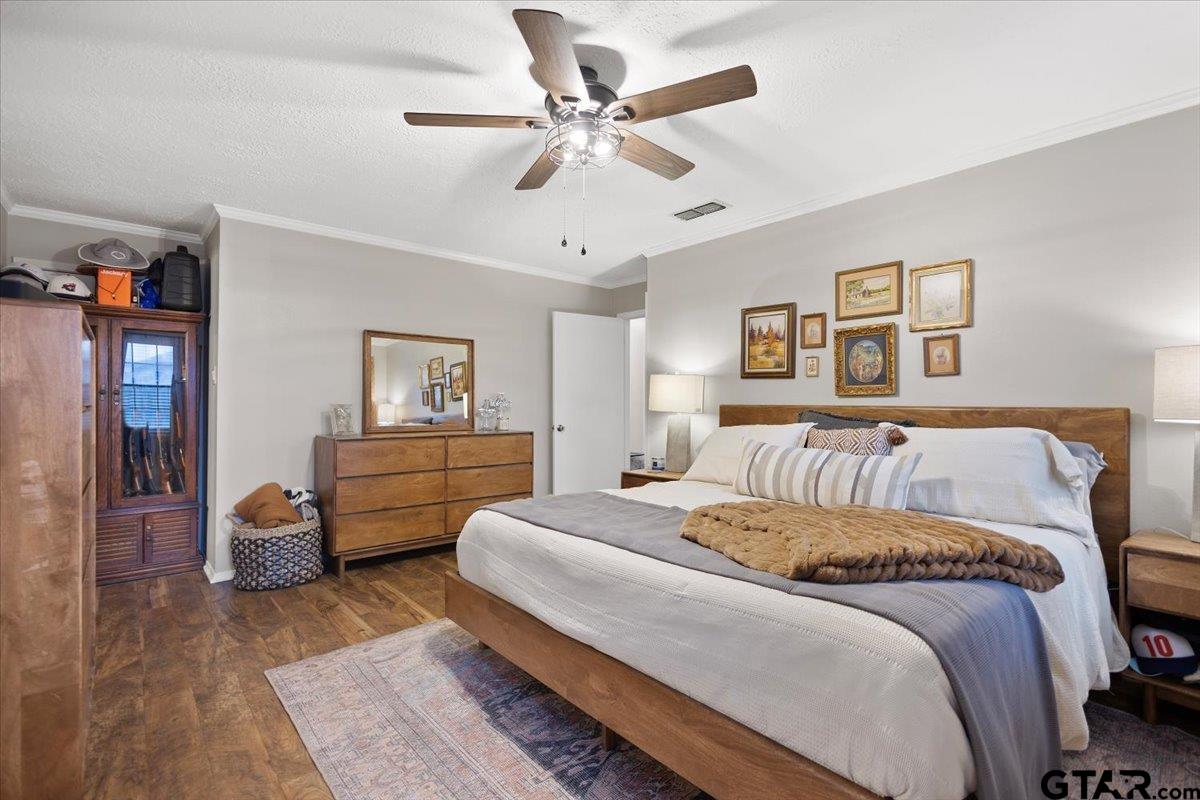 1606 Timothy Street Henderson, TX 75654 - Photo 13 of 33 a bedroom with a bed and wooden floor