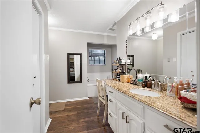 a bathroom with a granite countertop sink a mirror and a shower