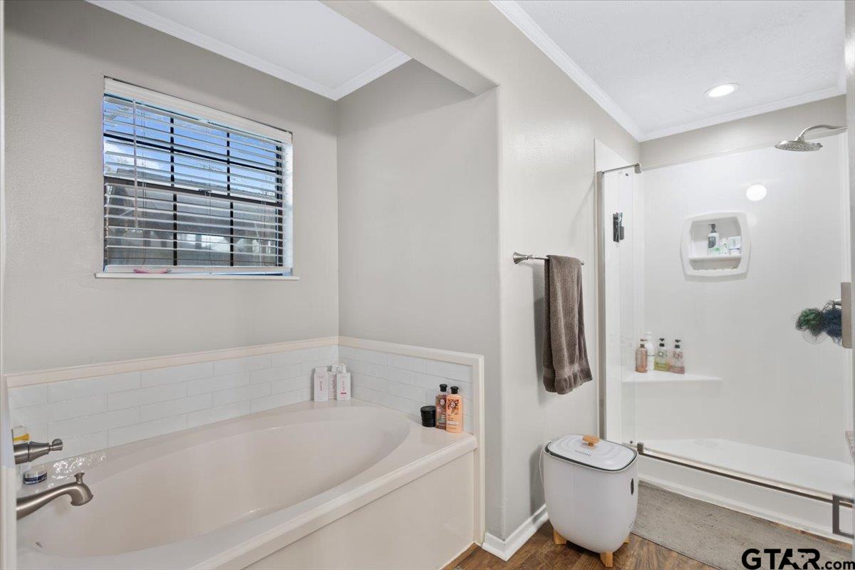 1606 Timothy Street Henderson, TX 75654 - Photo 16 of 33 a white bath tub sitting next to a white toilet and vanity