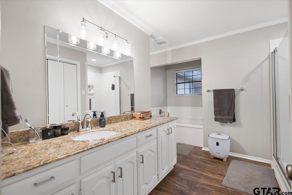 1606 Timothy Street Henderson, TX 75654 - Photo 17 of 33 a spacious bathroom with a double vanity sink and mirror