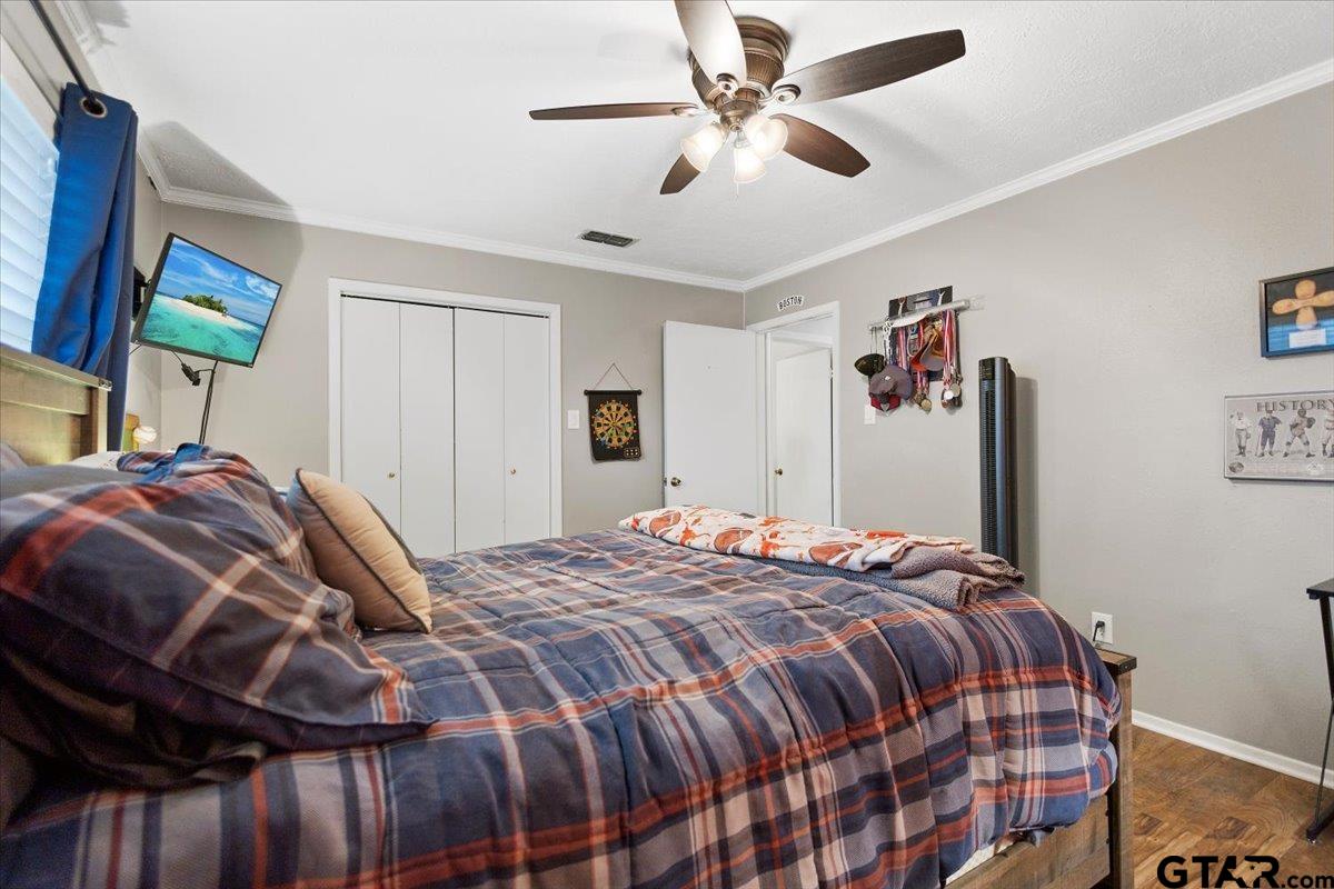 1606 Timothy Street Henderson, TX 75654 - Photo 21 of 33 a bedroom with a bed and a flat screen tv