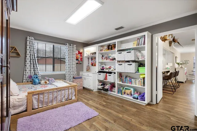 a bedroom with furniture and a book shelf