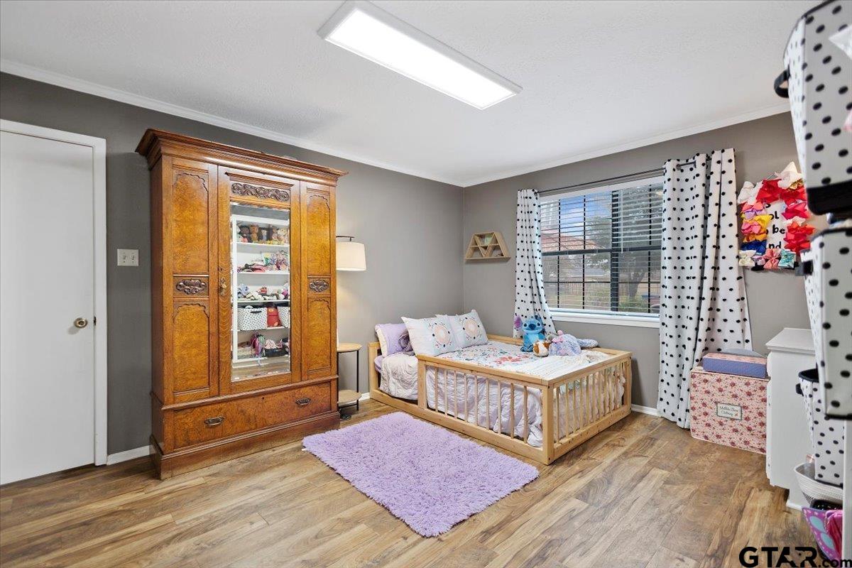 1606 Timothy Street Henderson, TX 75654 - Photo 26 of 33 a living room with a baby crib furniture and a window