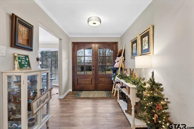 a hall way with furniture and a potted plant