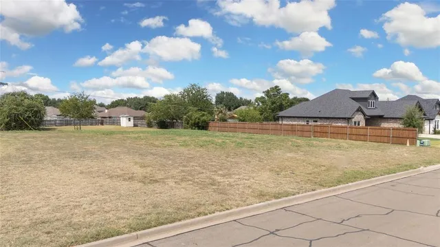 a view of a lake with houses in the back