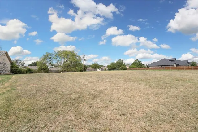 a view of a big yard with lots of green space
