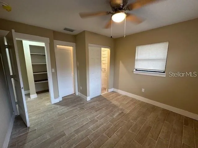 an empty room with fan and entrance