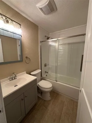 a bathroom with a double vanity sink toilet and shower